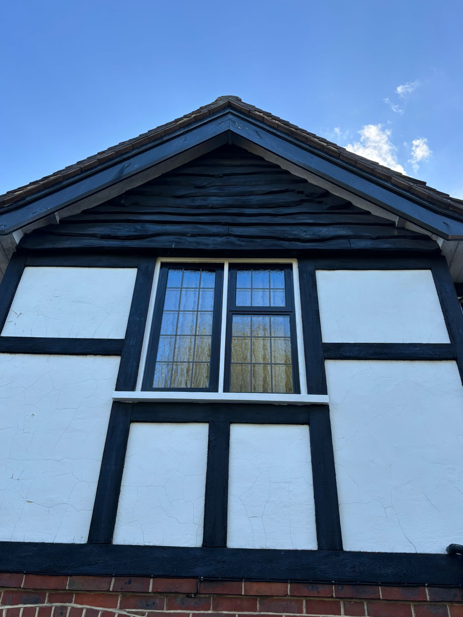 Restored mock-Tudor with curved tile detail